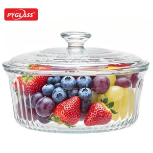Clear glass container with lid, filled with strawberries, blueberries, grapes, and other fresh fruit. Branded with Pyglass.