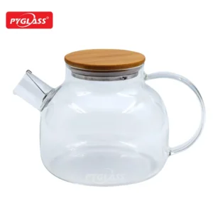 Clear glass teapot with a bamboo lid and handle, featuring a spout and the Pyglass logo.