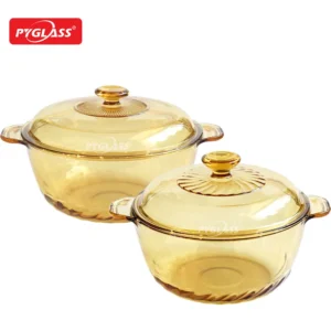 Set of two amber glass cooking pots with decorative lids by Pyglass, ideal for baking and serving.