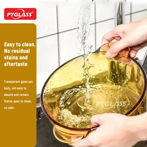 Hands holding a transparent Pyglass pot under running water, showcasing ease of cleaning with no residual stains.