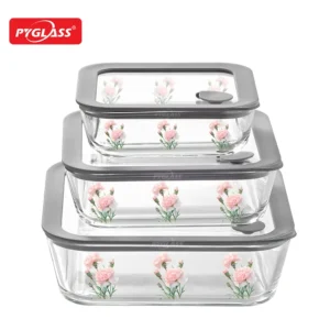 Three stackable Pyglass glass containers with floral design and gray lids, ideal for food storage.