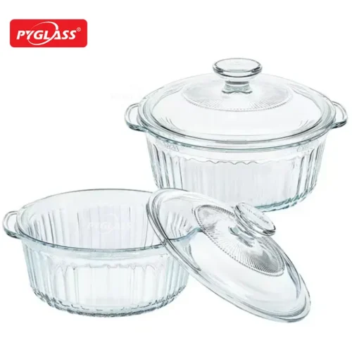 Two clear glass baking dishes with lids by Pyglass, featuring ribbed designs and handles, suitable for cooking and serving.