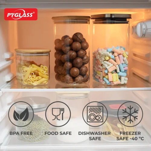Clear Pyglass storage containers holding pasta, nuts, and colorful marshmallows in a refrigerator, showcasing BPA-free, food-safe, dishwasher-safe, and freezer-safe features.