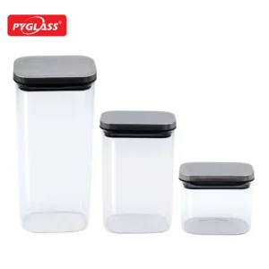 Three Pyglass clear storage containers in different sizes with airtight gray lids, ideal for kitchen organization.