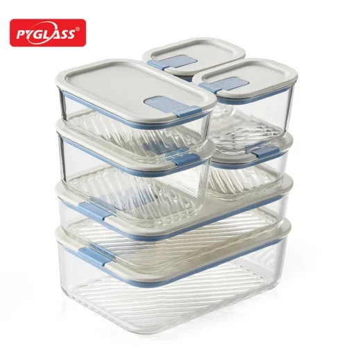 A stack of transparent glass food storage containers with white and blue airtight lids arranged neatly on a white background.